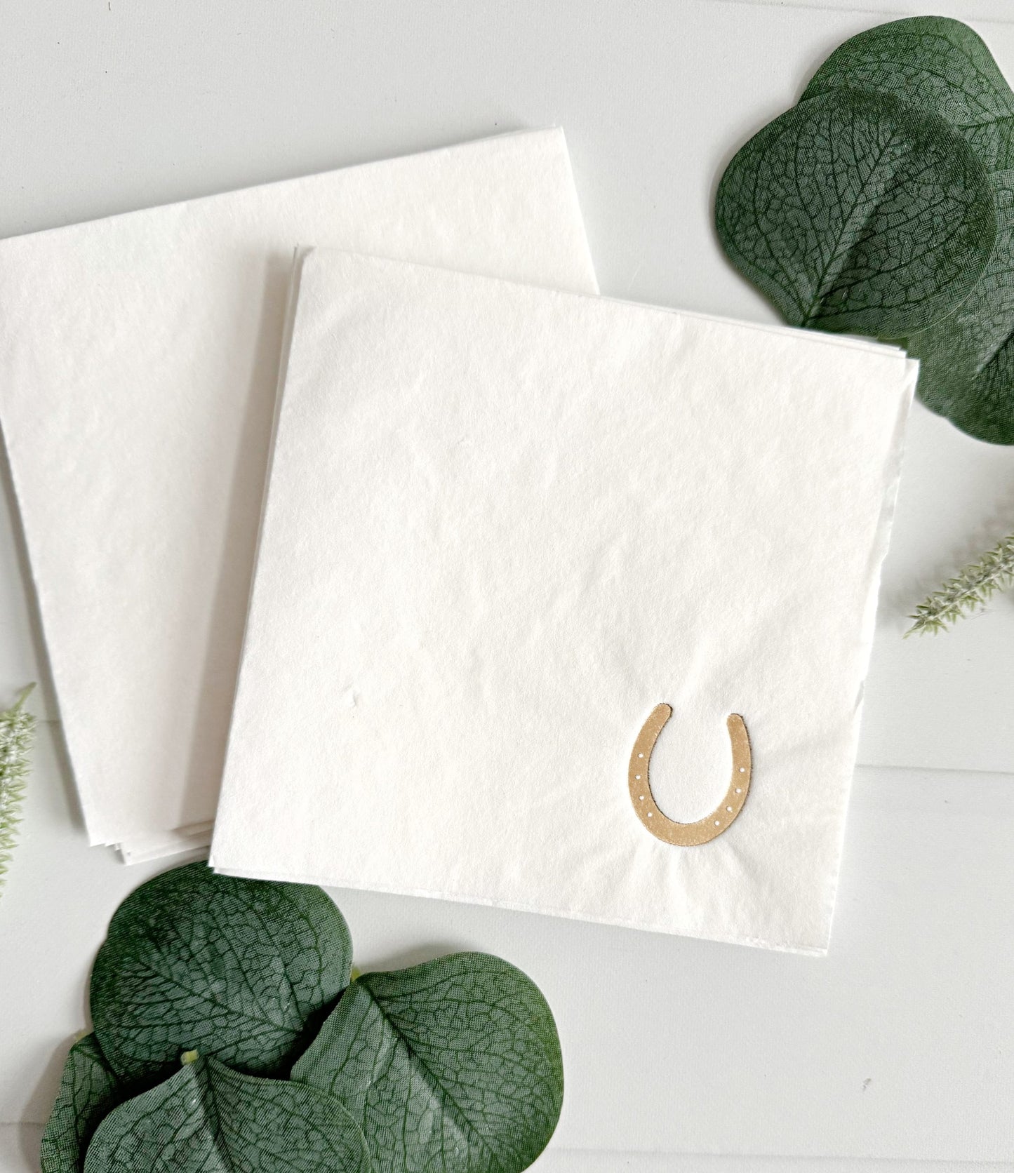 Add a sprinkle of luck and sophistication to your gathering with our elegant Kentucky Derby Gold Horseshoe Cocktail Napkins. These chic white napkins boast a stunning gold foil horseshoe design in the corner,