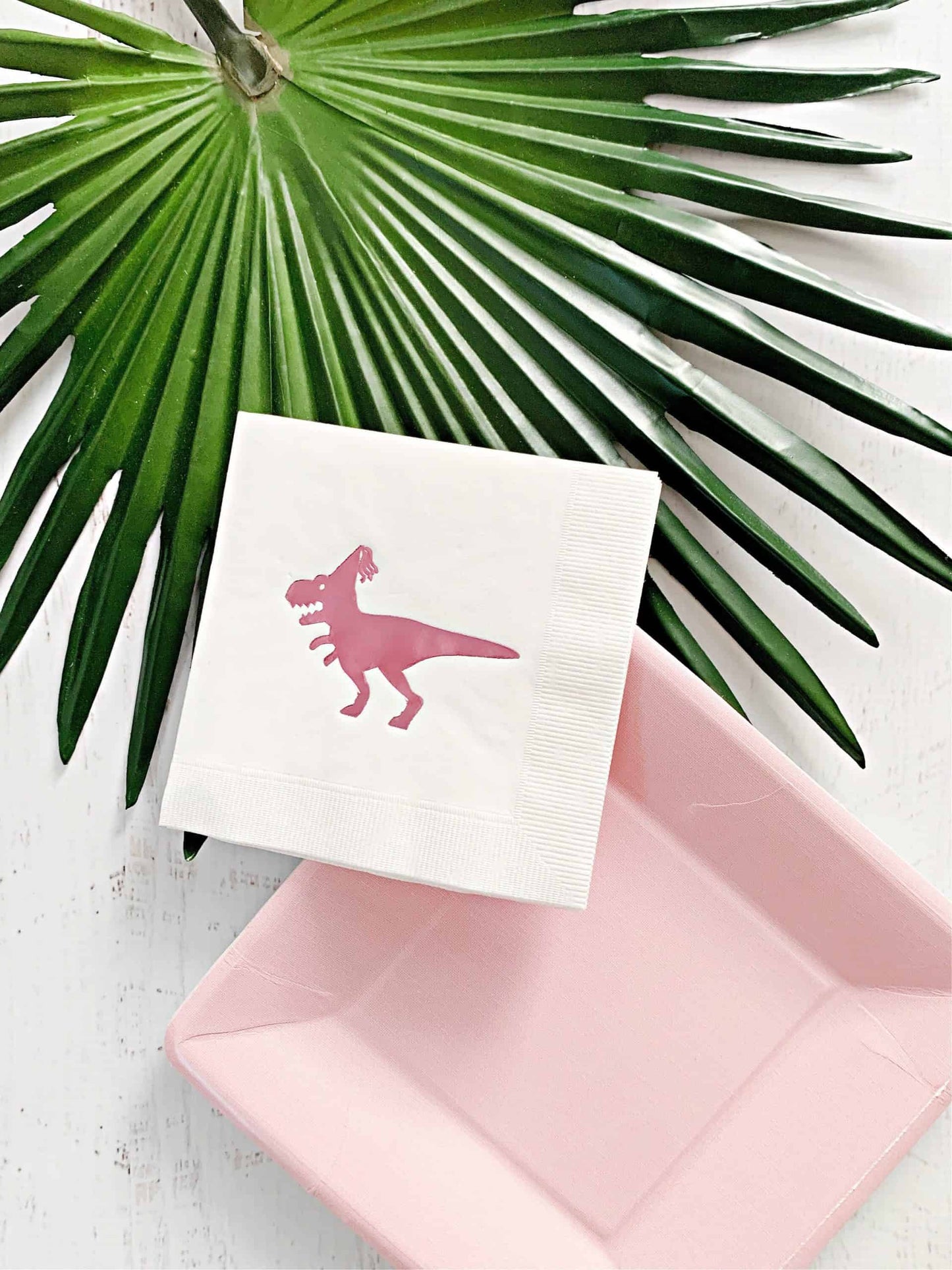 EnFete Pink on White Dinosaur Drink Napkins: Add a pop of color and style to your party with these EnFete signature pink on white dinosaur drink napkins. Perfect for your girl dinosaur party, these napkins feature cute and playful designs that your guests will love.