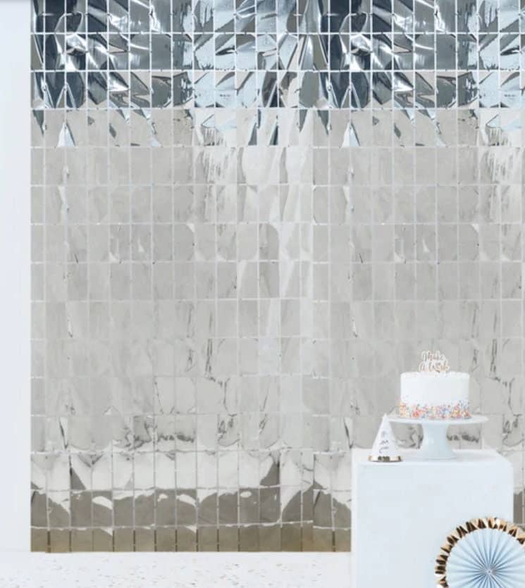 Transform your party space with our silver disco tile backdrop curtain. Create a groovy 70s vibe at your Two Groovy celebration. #TwoGroovy #DiscoVibes #PartySupplies.