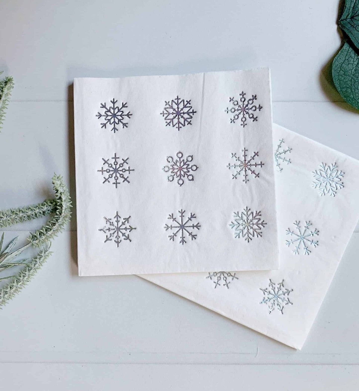 Snowflake holiday cocktail napkins for a Baby It's Cold outside baby shower or Christmas party bar.