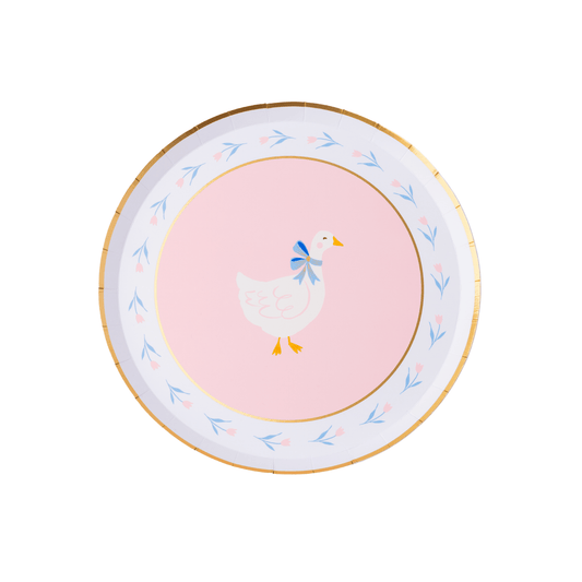 Round paper plate with a duck design on a pink background
