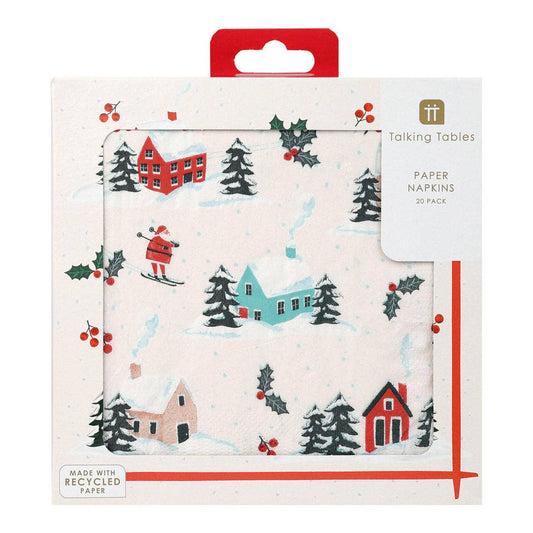 Pack of paper napkins with winter scene design, featuring houses, trees, and skiers, by Talking Tables.