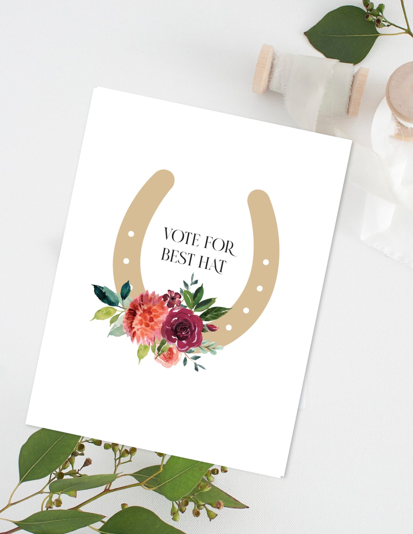 Card with a horseshoe and floral design on a white background Derby Vote for best hat