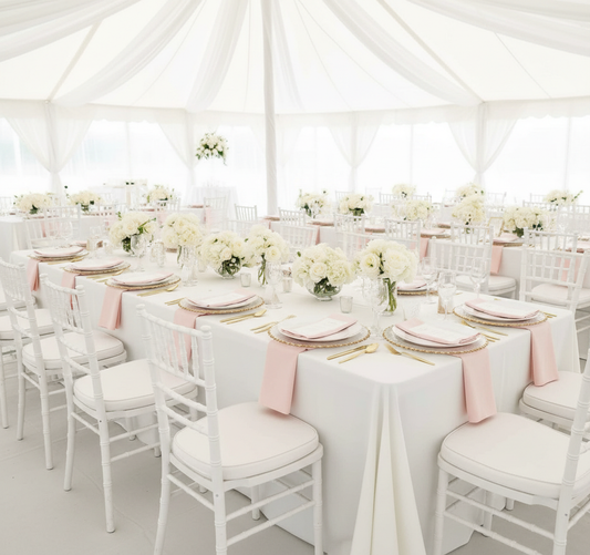 Bright white tent wedding with chargers