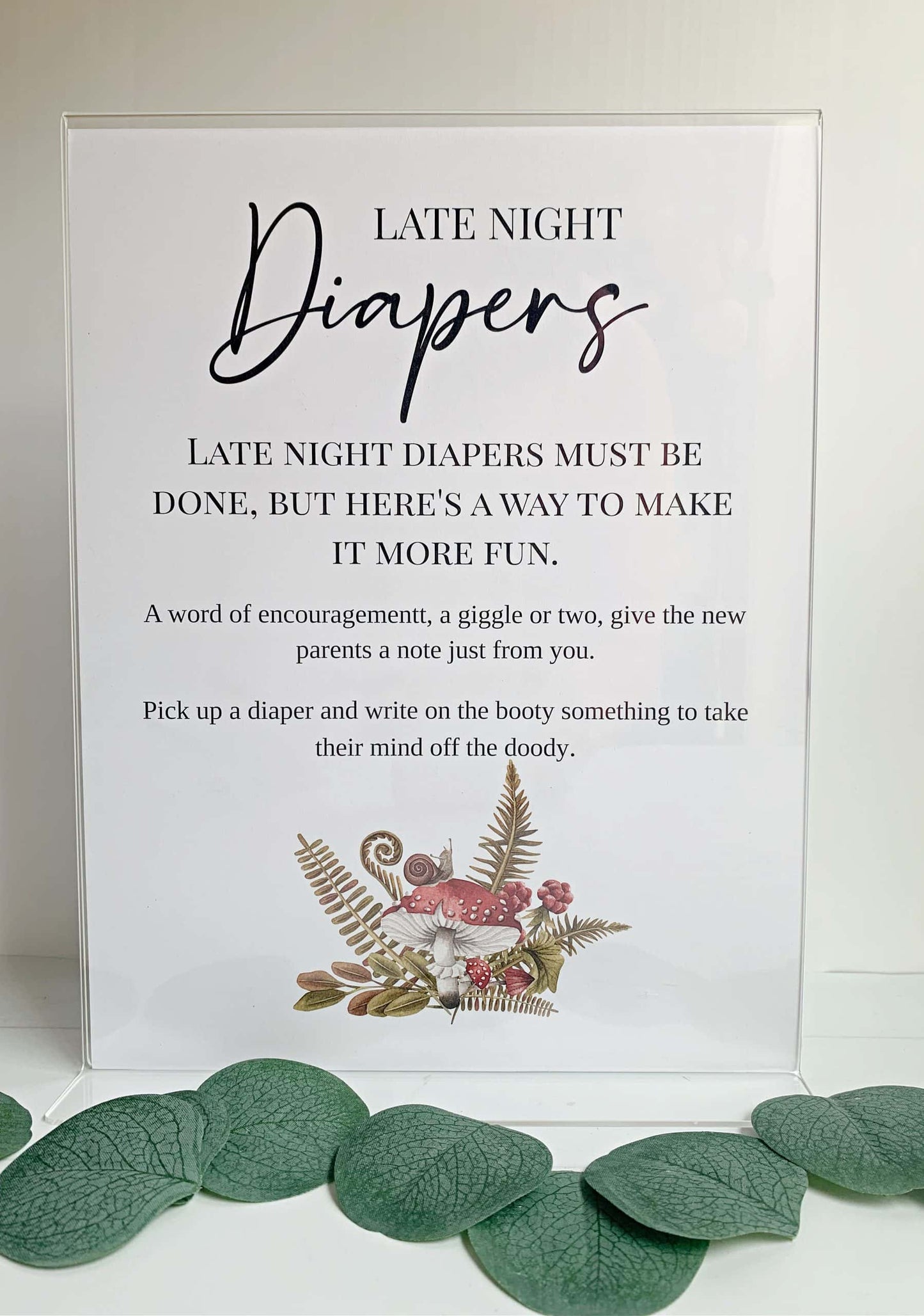 Elevate your baby shower with our charming PRINTED Late Night Diapers Game Sign. This woodland-themed sign features a captivating mushroom watercolor illustration, adorned with forest green lettering, creating a delightful and whimsical touch to your event.
