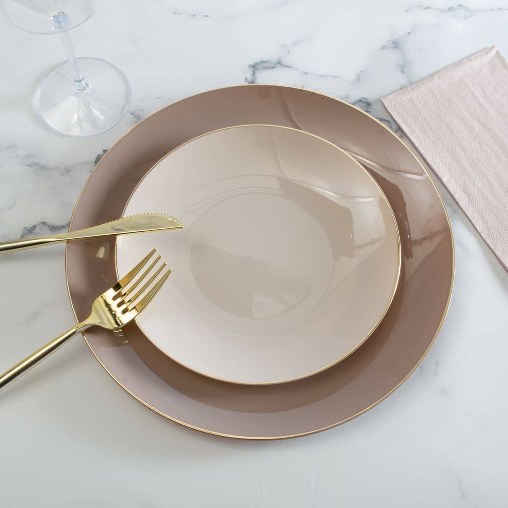 Set of beige plates with gold rims on a marble surface
