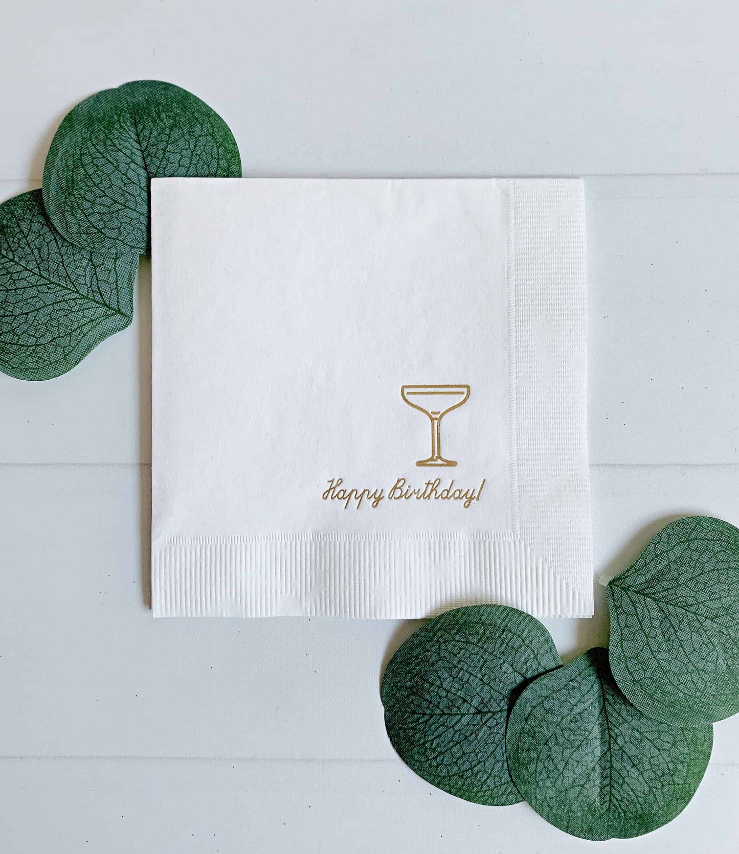 Happy Birthday Coup Glass - Gold on White Napkin