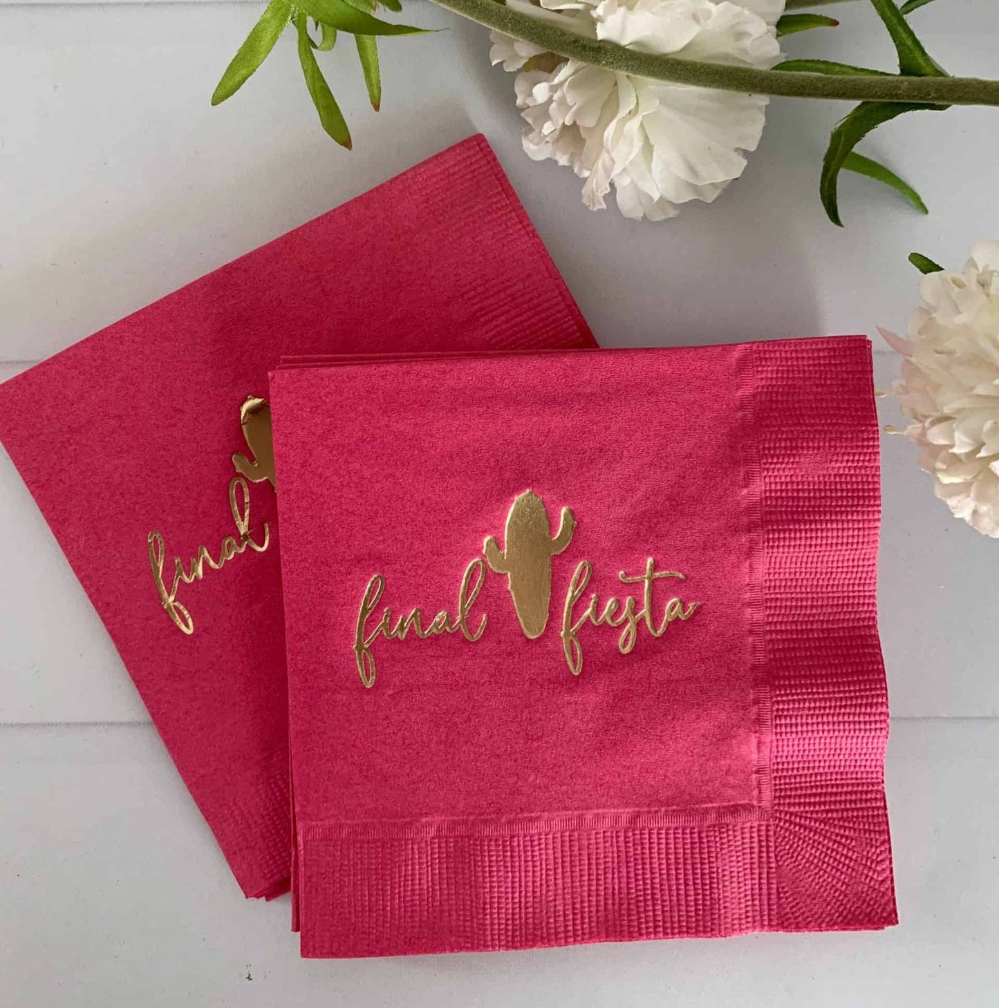 Her final fiesta napkins in hot pink with gold writing and a gold cactus Say goodbye to the single life in style with our "Her Final Fiesta" napkins in hot pink with gold writing and a gold cactus. These stylish napkins feature a fun hot pink color, shimmering gold writing, and a playful gold cactus design, making them the perfect choice for a bachelorette party or bridal shower. Whether you're serving cocktails, appetizers, or simply adding a touch of fun to your decor, these napkins are sure to impress. S