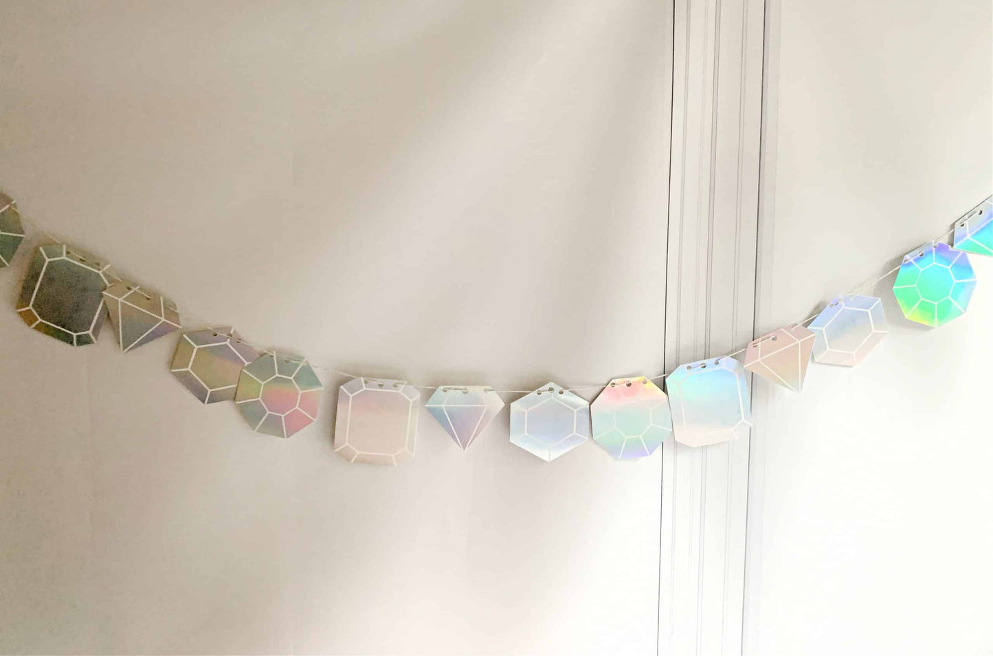 Get ready to dance the night away with our Last Disco Bachelorette Garland with Iridescent Diamond Cutouts. This stunning garland features 17 iridescent diamond cutouts that shimmer and shine, making it the perfect choice for a bachelorette party or any other celebration. The iridescent finish adds a touch of glamour and sparkle, making it a versatile choice for a variety of themes and color schemes. Whether you're decorating a venue or simply adding a touch of fun to your room, this garland is sure to brin