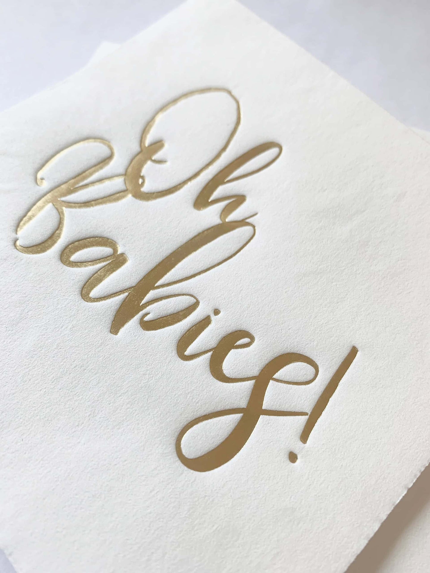 The gorgeous gold foiled scripted writing on these Oh Babies cocktail napkins looks elegant on a neutral white background. Use the napkins for treats and to protect those baby shower outfits! All that's left to do is enjoy this special moment at the twin's baby shower with family and friends.