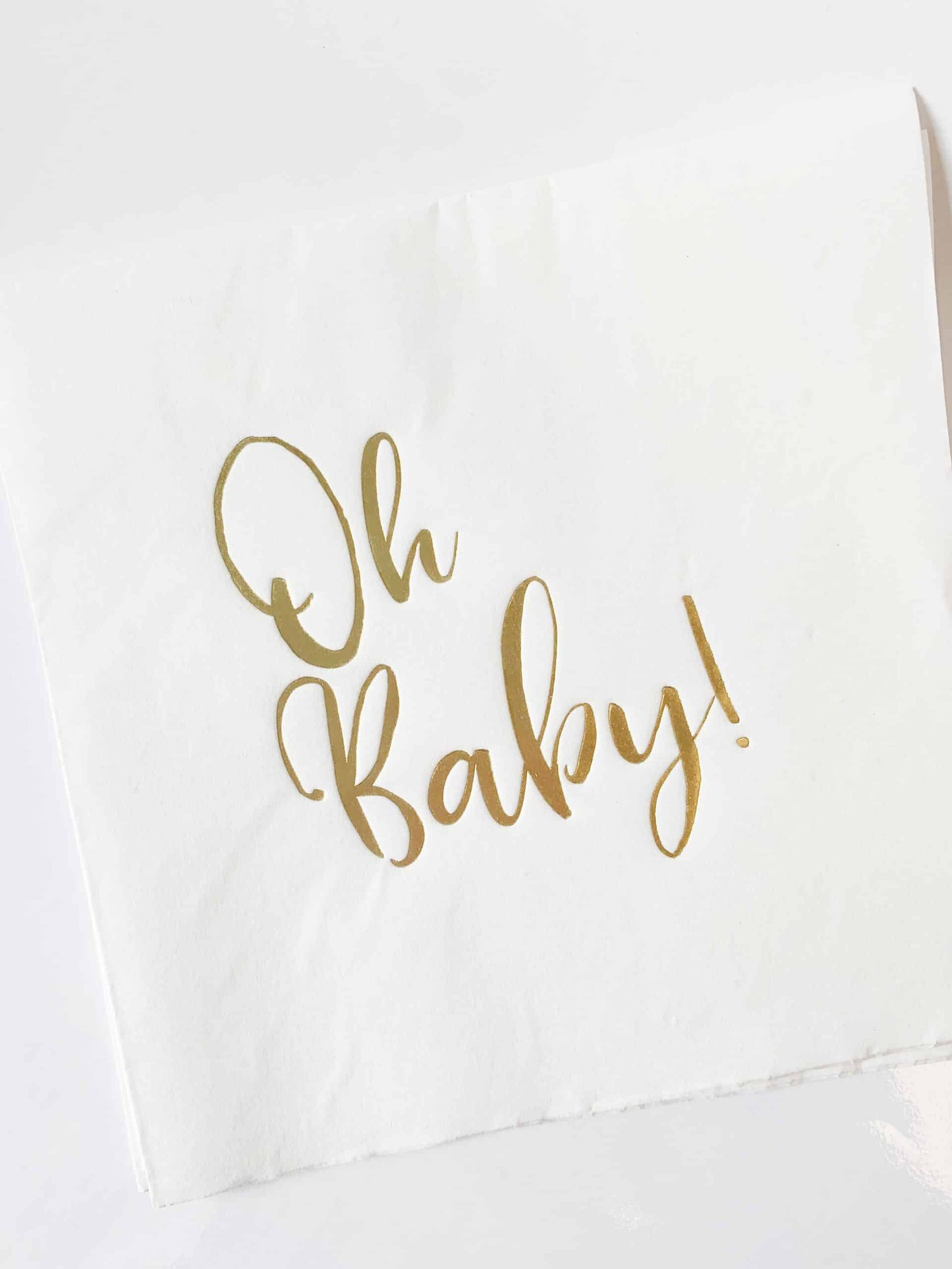 Welcome your new little one in style with our beautiful "Oh Baby" luncheon napkins. Featuring gold foil script on white napkins, these napkins are the perfect accent to your baby shower and will add a touch of boho-chic with classic elegance to your celebration. The neutral palette makes these napkins perfect for baby girls or baby boys, and they're a great choice for a Safari baby shower, Oh Baby shower, or any other theme. Product Details: 16 "Oh Baby" luncheon napkins per pack Gold foil script on white n