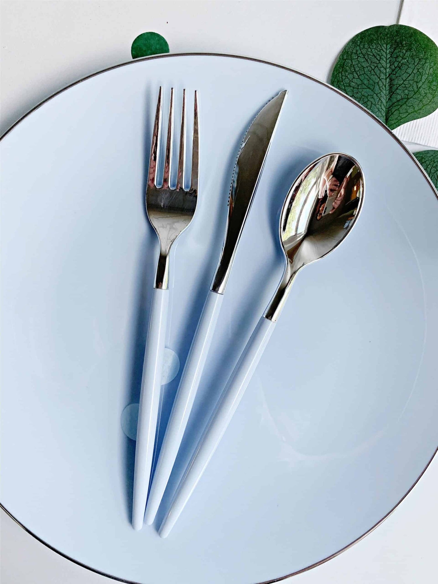 Ice Blue Baby Shower Party Supplies like these utensils on an ice blue plastic dinner plate.