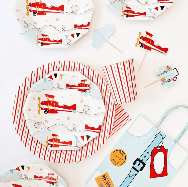 Airplane themed party supplies for a birthday party or baby shower - red, grey, sky blue and white colors.