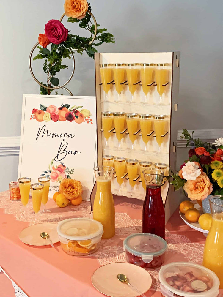 Mimosa bar setup complete with our wooden champagne stand and juice carafes - the perfect drinks stand and display for your party.