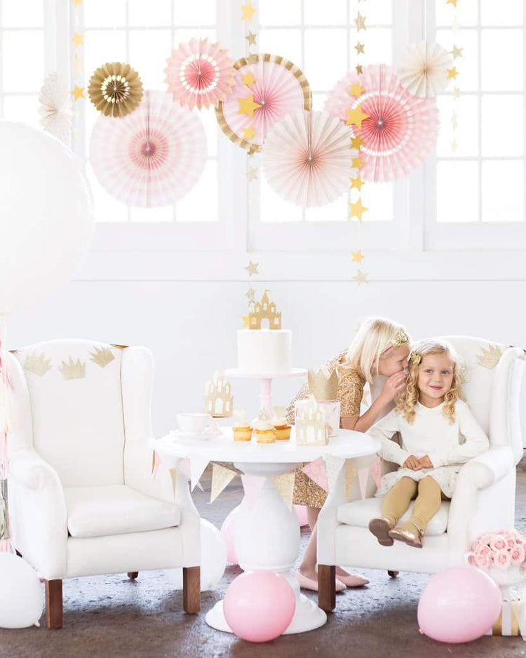 Party Fan Decorations Hanging from the ceiling at a little girl's princess party