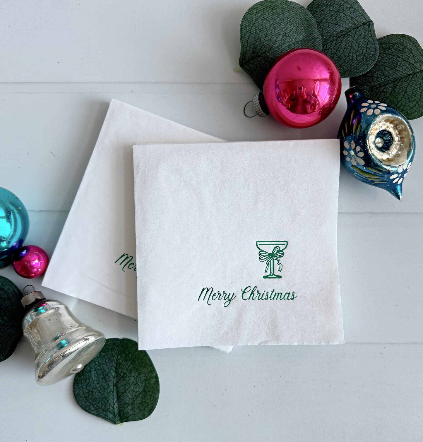 Celebrate the holiday season in style with our Merry Christmas Coup Glass with Bow Cocktail Napkins. These elegant napkins feature a sophisticated coup glass design adorned with a chic bow