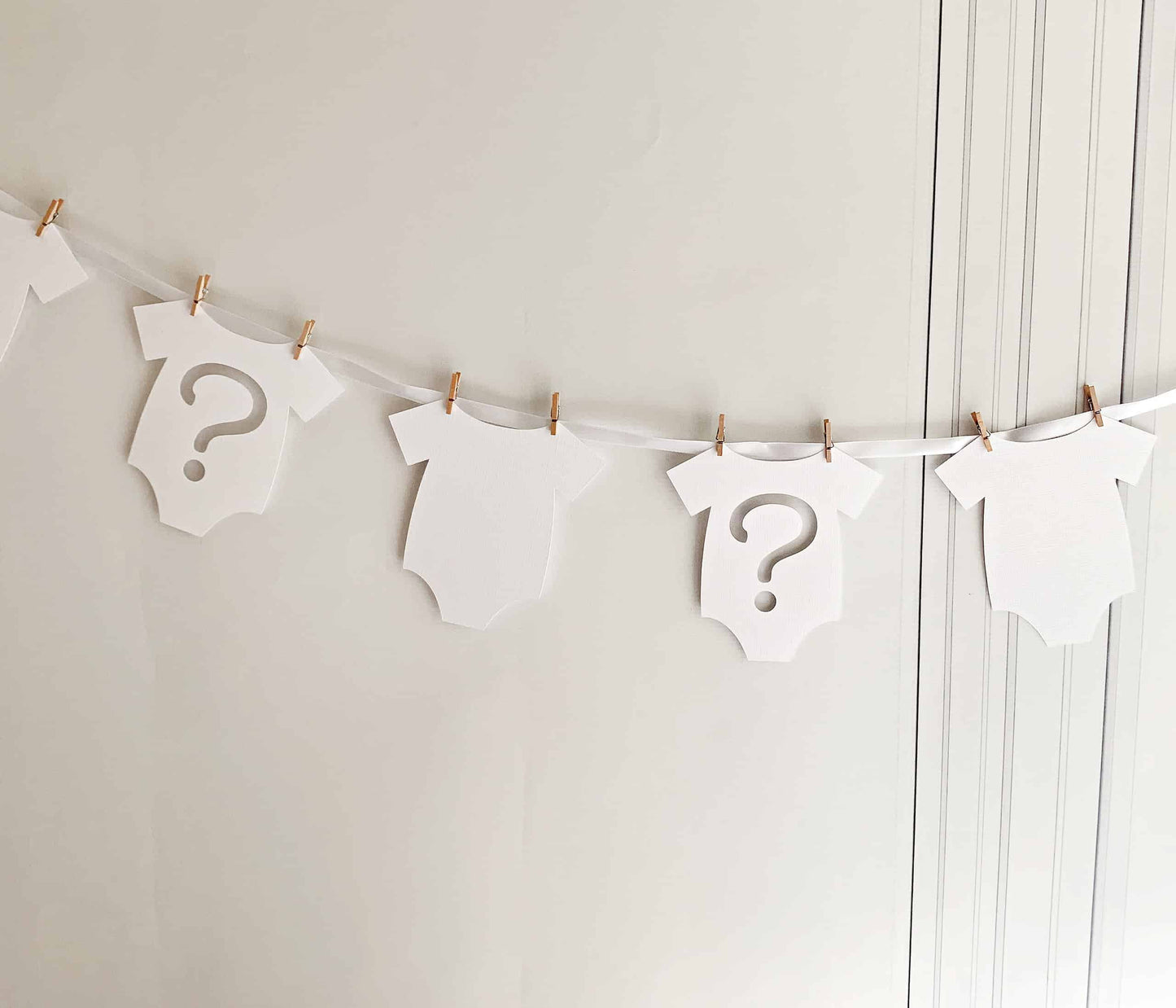 Introducing our charming White Gender Reveal Onesie Banner, perfect for celebrating the boy or girl on the way! This delightful banner features 7 adorable onesie-shaped cutouts, crafted with care and handmade exclusively by EnFete.