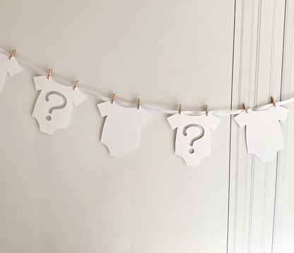 Introducing our charming White Gender Reveal Onesie Banner, perfect for celebrating the boy or girl on the way! This delightful banner features 7 adorable onesie-shaped cutouts, crafted with care and handmade exclusively by EnFete.
