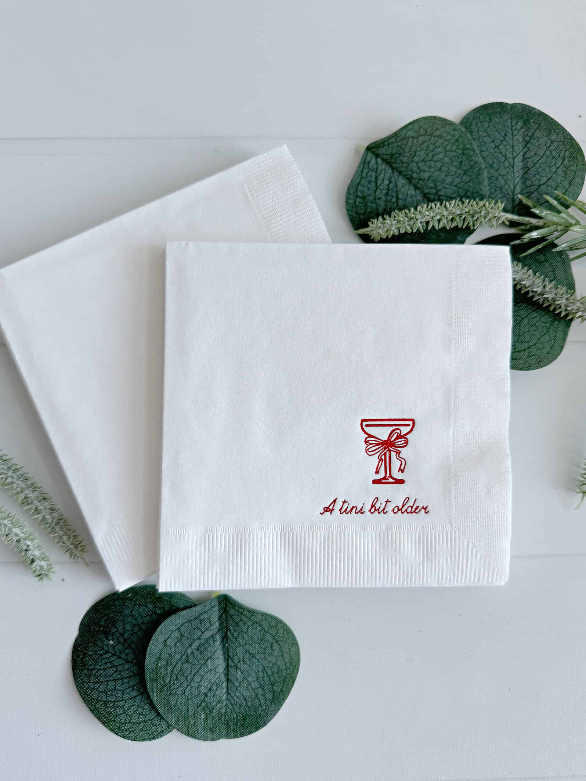 levate your birthday celebrations with EnFete's Cocktail Napkins with Red Foil "Just a tini bit old" Coup Glass and Red Bow Birthday Cocktail Napkins. Perfect for a holiday or December birthday!