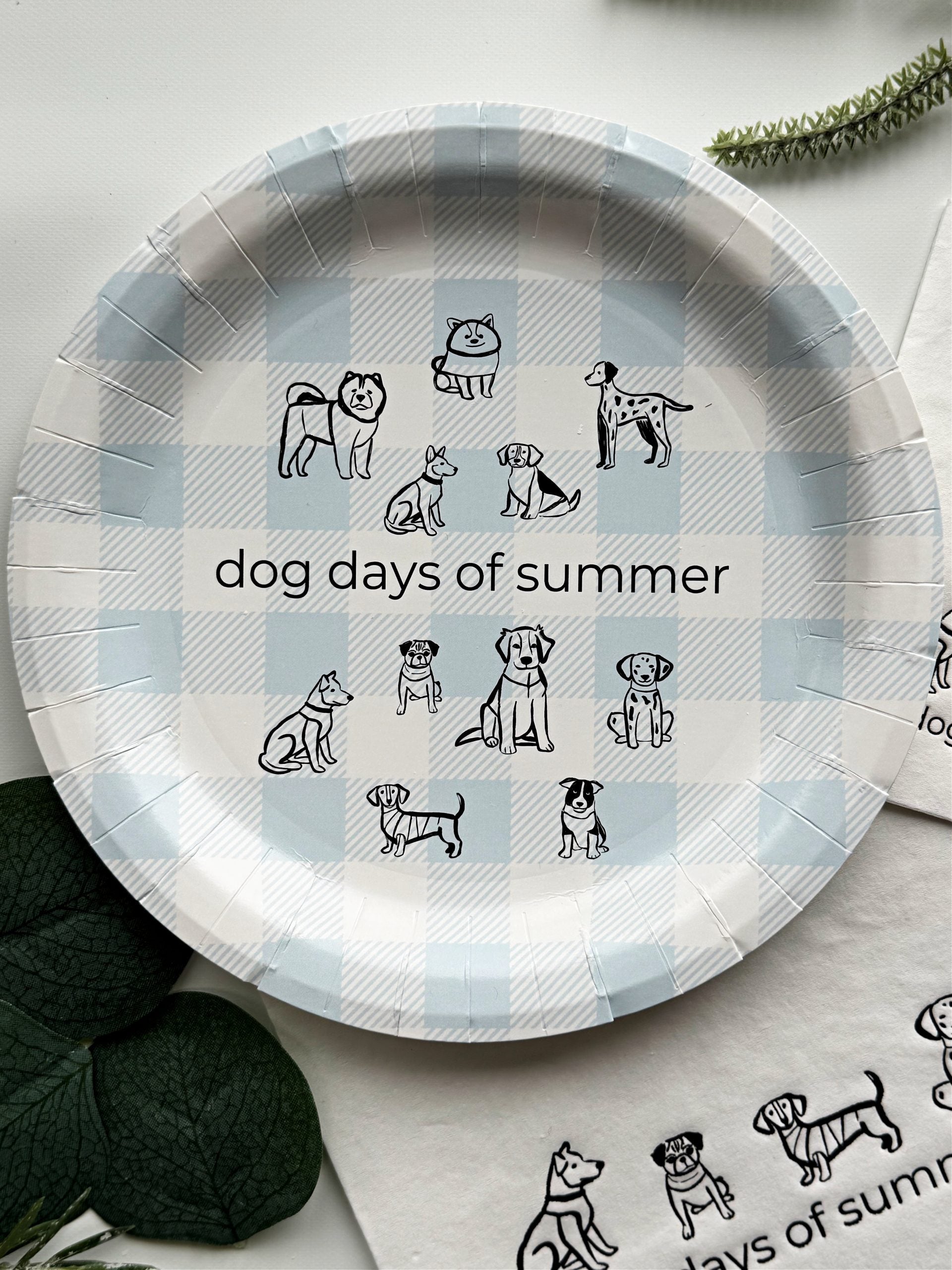 Introducing the charming "Dog Days of Summer Cake Plate" set, featuring a delightful design of playful pen illustration dogs frolicking on a cool ice blue gingham background. This set includes 8 paper cake plates, each measuring 7 inches in size, making them ideal for serving up slices of cake or small bites at your next summer gathering.