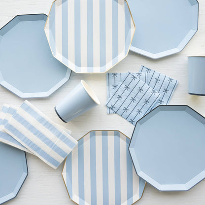 Hexagonal plates and cups with blue and white patterns on a light background
