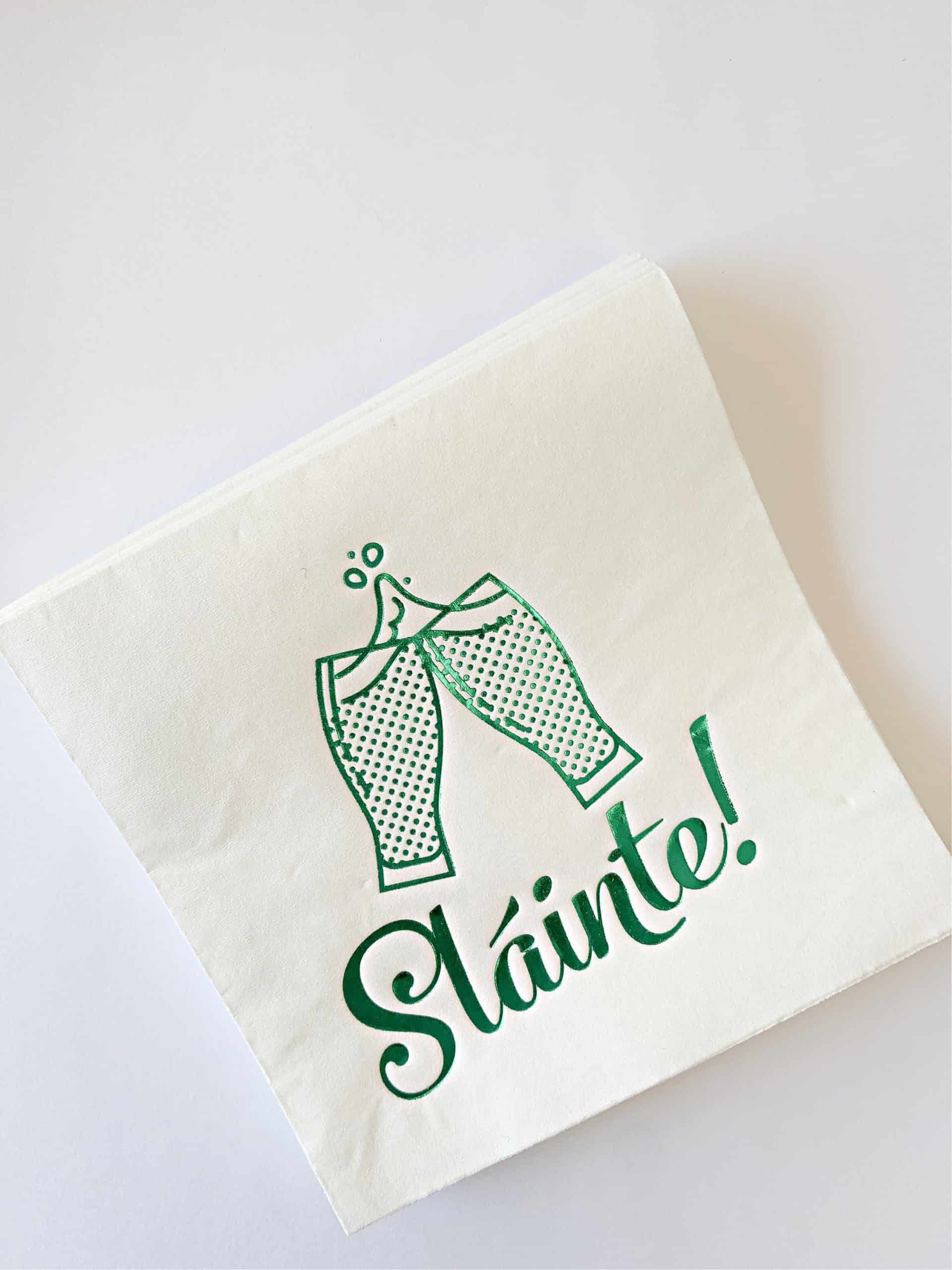 Slaint Irish Cheers Cocktail Napkins for St Patrick's Day or an Irish Wedding. White paper napkins with bright green foil imprint.