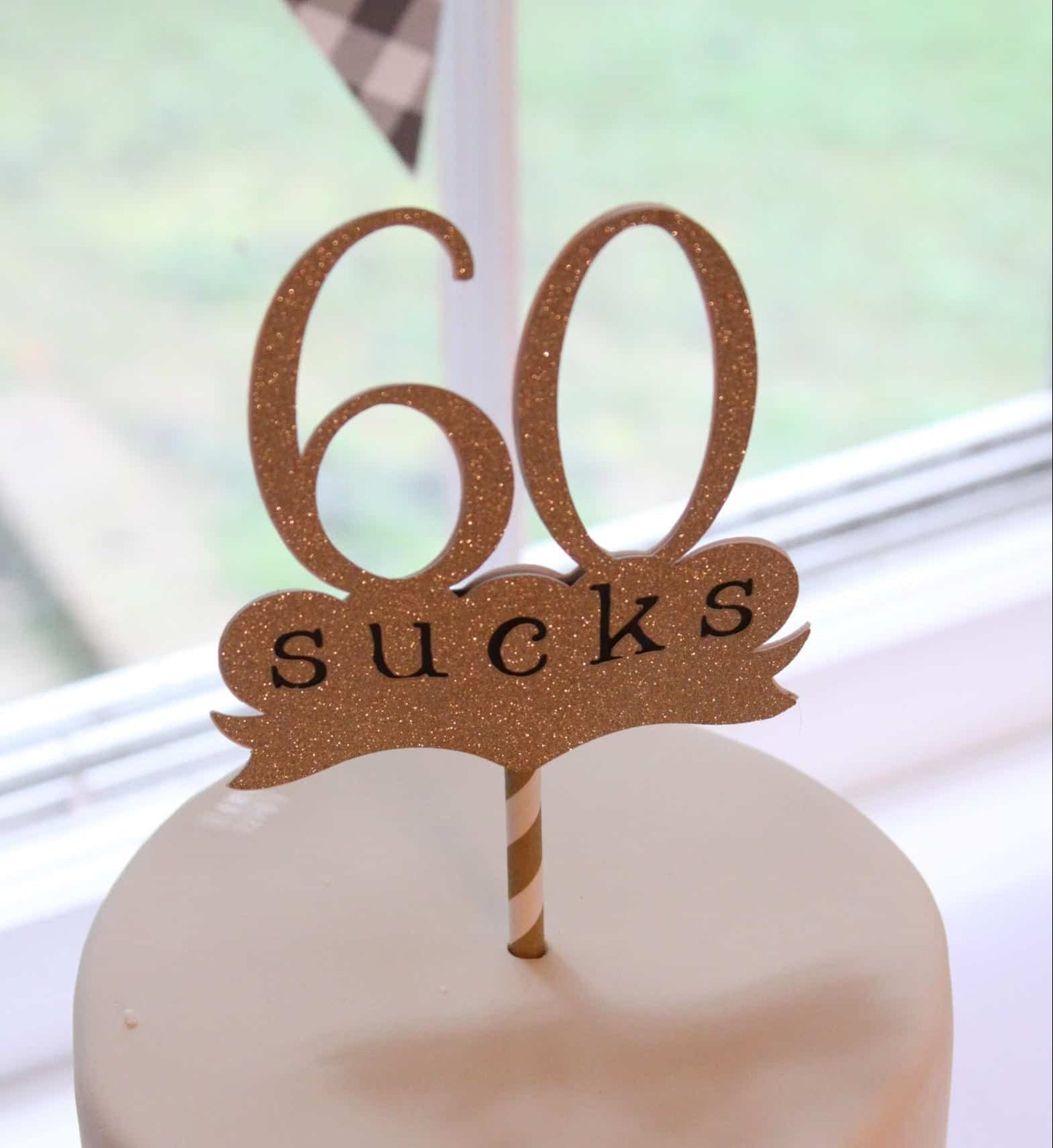 60 sucks milestone cake topper for a 60th birthday party in gold and black
