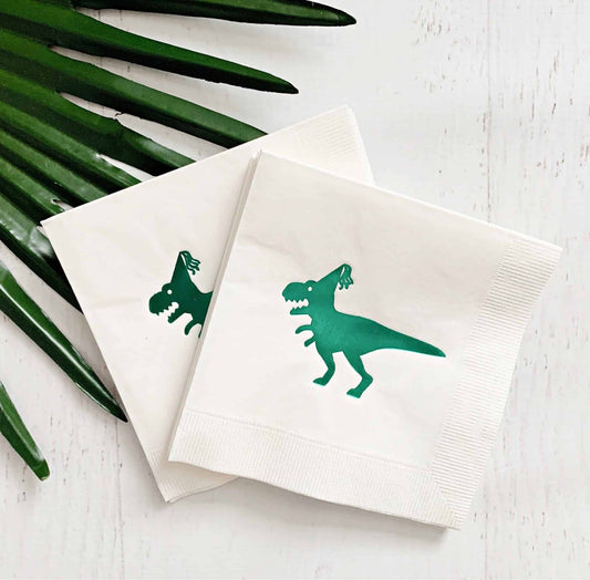 Introducing our EnFete original design green dinosaur drink napkins, perfect for your dinosaur-themed party! These napkins feature a beautiful shiny green foil dinosaur, adding a touch of whimsy to your celebration. The folded size of 4.5 x 4.5 inches makes them perfect for drinks or as kid-sized napkins.