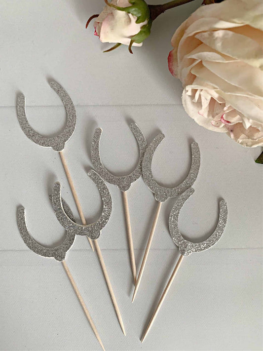 Six silver glitter horseshoe-shaped cupcake picks mounted on food-safe toothpicks, perfect for adding a touch of charm to your Kentucky Derby party or horse-themed event. #KentuckyDerbyParty #HorseThemedParty #DerbyPartyDecor #CupcakePicks #SilverGlitter #EnFeteParty