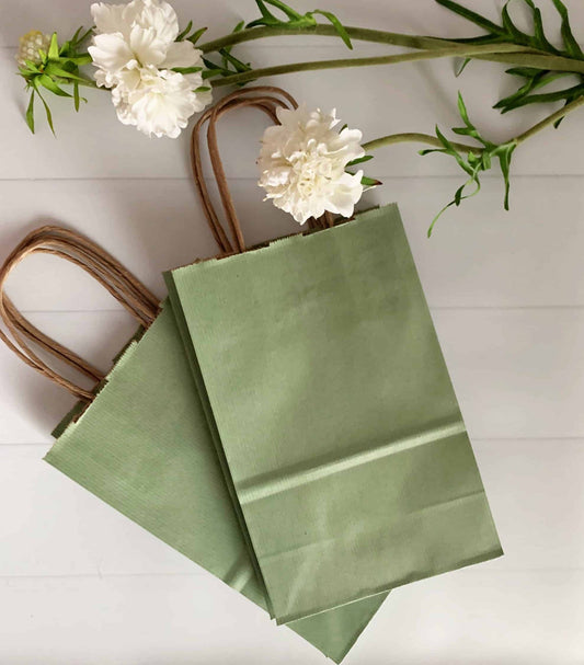Make your party favors and gifts extra special with our soft Sage Green Favor and Gift Bags. Perfect for a safari baby shower, Little Cutie, or other greenery-themed party, these favor bags are a charming and stylish addition to your celebration. Each set includes 10 sage green bags, each measuring 5.5 x 3.25 x 8.375". The high-quality materials used in the bags ensure durability and sturdiness, making them perfect for wrapping a variety of favors and gifts. To add an extra touch of elegance and personaliza