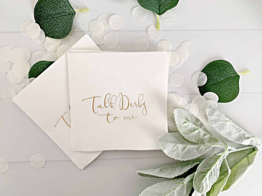 Upgrade your Kentucky Derby party with these stylish "Talk Derby to Me" white Elevate your Kentucky Derby party with EnFete's original and elegant Kentucky Derby napkins. Add sophistication to your celebration. #KentuckyDerby #ElegantNapkins #EnFete.cocktail napkins. Perfect for any Derby themed celebration, these napkins add a touch of sophistication with their simple and elegant design. Shop now to elevate your party and impress your guests with these premium quality napkins. #KentuckyDerby #DerbyParty #C