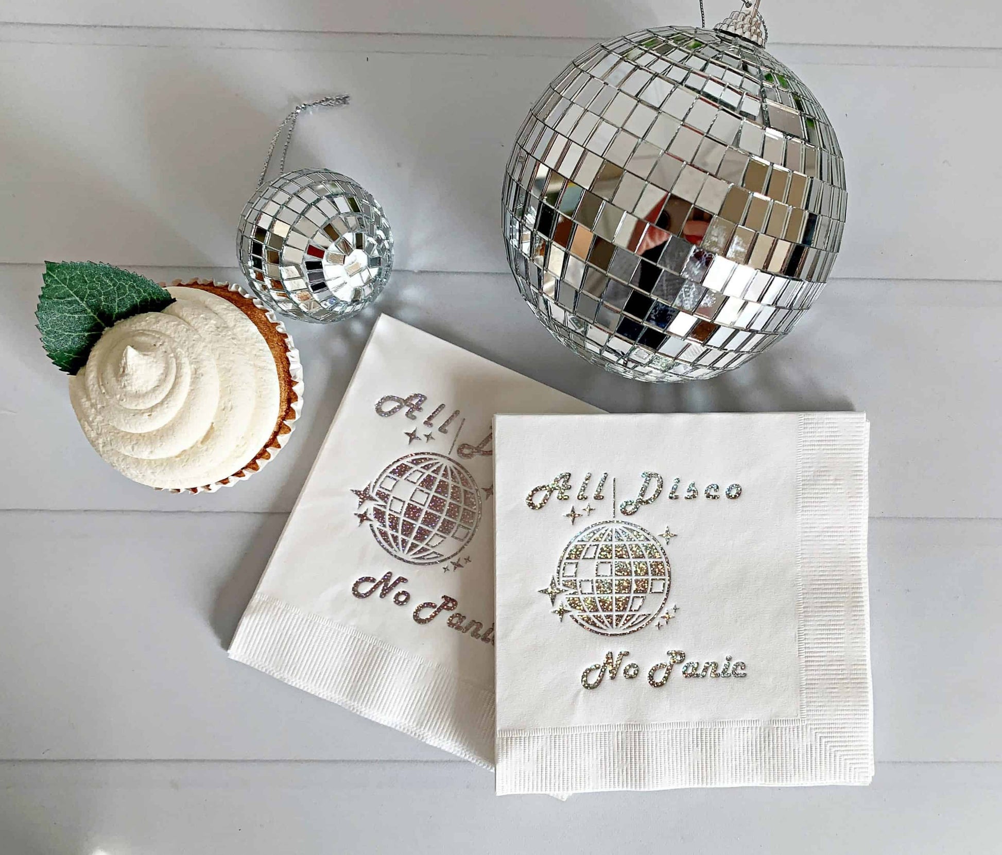 Our white All Disco No Panic cocktail napkins are perfect for this bachelorette party theme. They feature a striking gold glitter disco ball design that adds a touch of glamour and playfulness to the party. These napkins come in packs of 16 and are made of high-quality paper, ensuring that they hold up well throughout the evening. They are perfect for serving drinks and appetizers and are sure to impress your guests. Plus, they make a great keepsake for the bride-to-be to remember her special night with her
