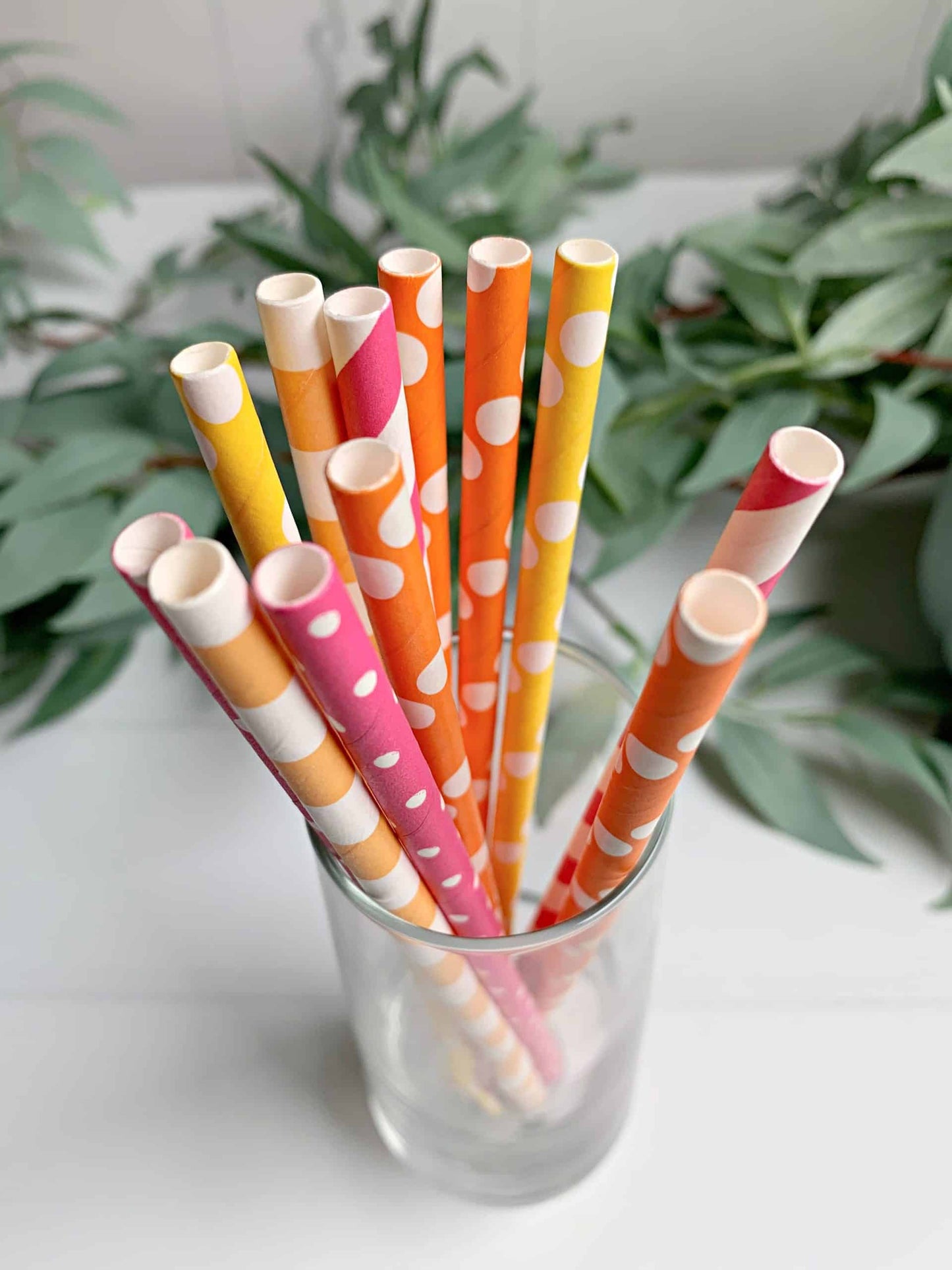 A set of 12 bright citrus straws in shades of orange, apricot, hot pink, and lemon yellow, perfect for a citrus wedding, a little cutie baby shower, or She Found Her Main Squeeze bridal shower.
