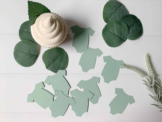 Shop our unique sage green onesie shaped confetti cutouts for the perfect addition to your baby shower. Add a pop of color to the celebration with our stylish and trendy confetti cutouts." #BabyShower #OnesieConfetti #SageGreen