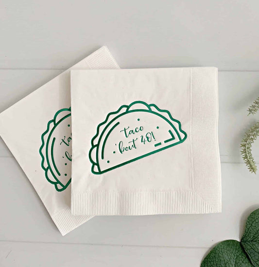 Add a touch of fun to your next fiesta or taco party with our "Taco Bout 40" cocktail napkins in green on white. These playful napkins feature a bright green design and humorous message, making them the perfect choice for a milestone birthday celebration or any fun-filled event. The high-quality material ensures they are both durable and absorbent, making them suitable for both indoor and outdoor events. So, get ready to taco 'bout a good time with our "Taco Bout 40" cocktail napkins.