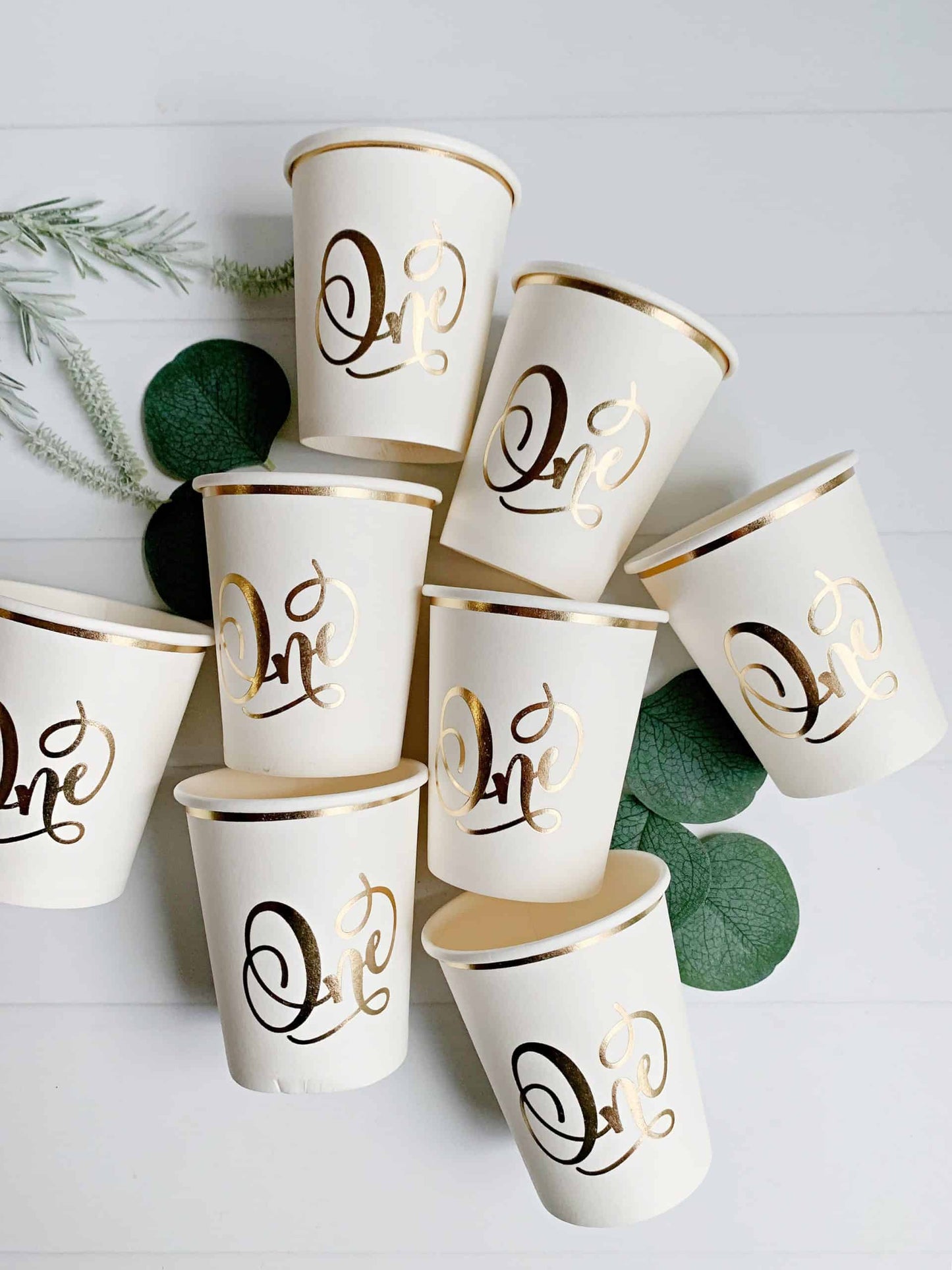 Gorgeous foiled gold 'one' cream paper cups for a memorable first birthday celebration. #FirstBirthday #GoldFoil #CelebrateInStyle