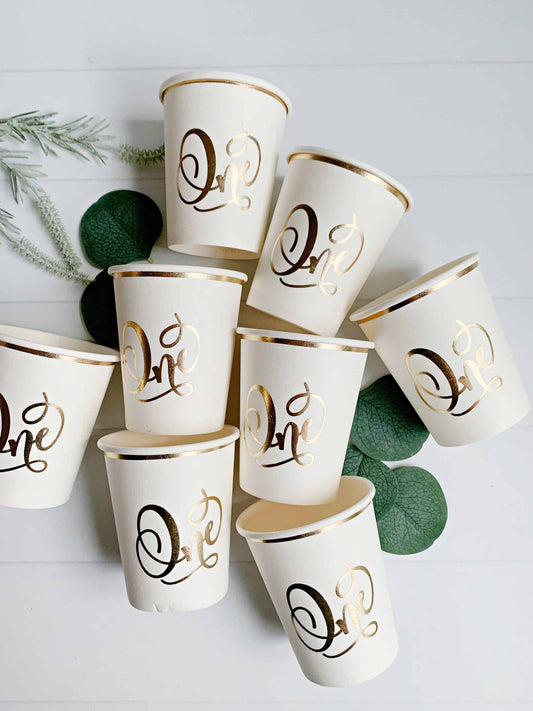 Gorgeous foiled gold 'one' cream paper cups for a memorable first birthday celebration. #FirstBirthday #GoldFoil #CelebrateInStyle