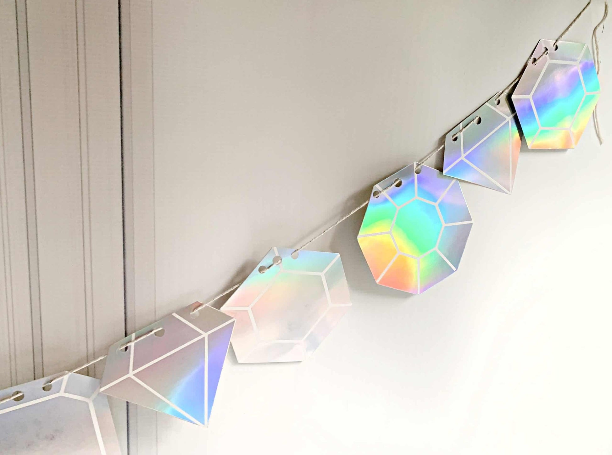 Get ready to dance the night away with our Last Disco Bachelorette Gem Garland with Iridescent Diamond Cutouts. This stunning garland features 17 iridescent diamond cutouts that shimmer and shine, making it the perfect choice for a bachelorette party or any other celebration. The iridescent finish adds a touch of glamour and sparkle, making it a versatile choice for a variety of themes and color schemes. Whether you're decorating a venue or simply adding a touch of fun to your room, this garland is sure to 