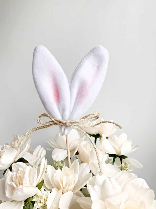 Add a touch of whimsy to your Easter celebration with our white bunny ears centerpiece pick. Perfect for decorating tables, baskets, and more. #Easter #BunnyEars #Centerpiece #TableDecor