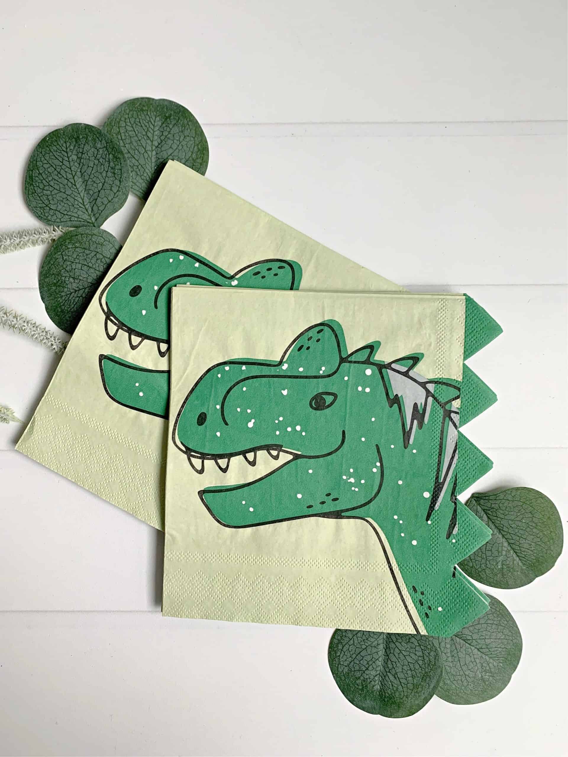 Add a touch of prehistoric fun to your child's birthday party with these Dinosaur Napkins! Each pack includes 16 high-quality 2-ply paper napkins with a green background and a playful dinosaur face, complete with a spiked edge. Measuring at 6.5", these napkins are perfect for lunch or snacks and will add a touch of whimsy to your table setting. Pair with our matching paper tableware collection, plates, cupcake toppers, and other dino-mite party supplies to complete your prehistoric party!