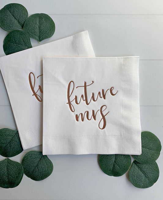 Elevate your bridal shower or bachelorette party with these stunning Future Mrs. Napkins! This set of 16 three-ply white tissue napkins features a beautiful and elegant rose gold foil script detailing that reads "Future Mrs." on the front of each napkin.