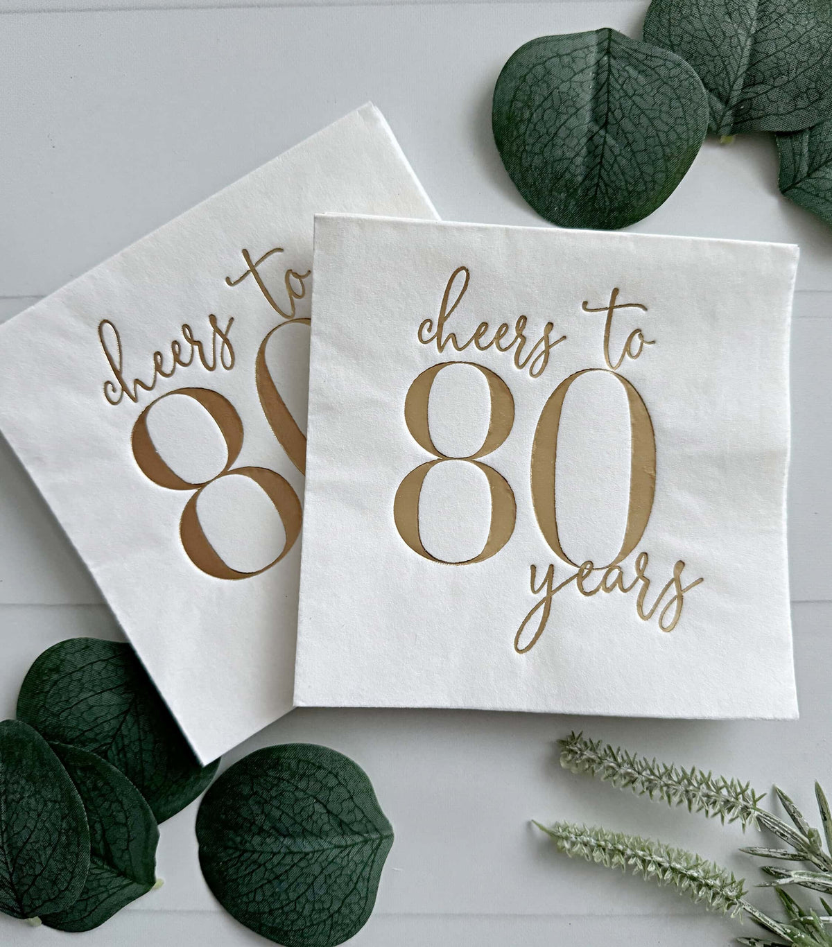 
    Cheers to 80 Years Cocktail Napkins – White &amp; Gold Foil, the designer-recommended anchor napkin for the 80th Birthday Party Supplies &amp; Decorations collection
  