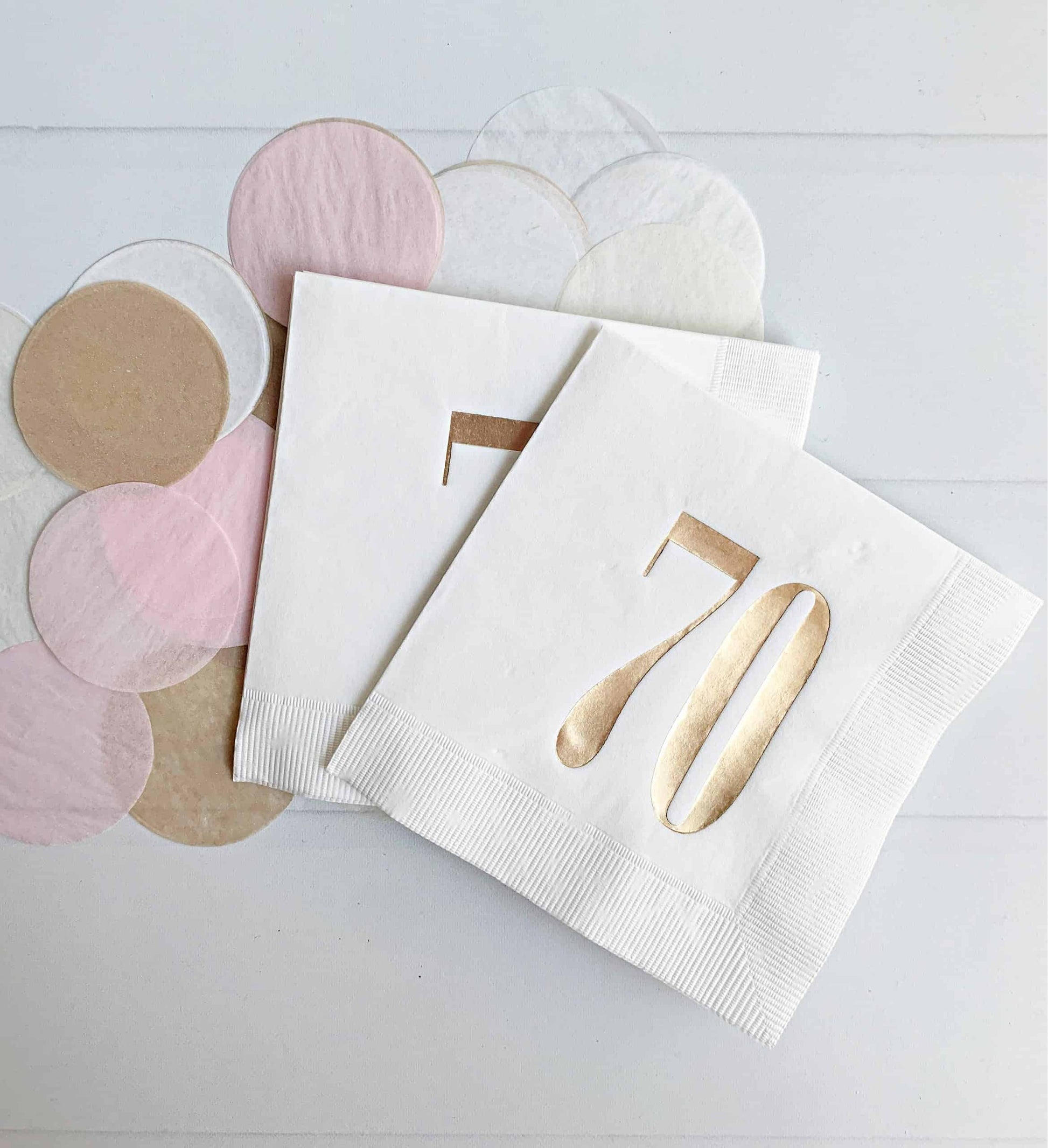 These beautiful napkins feature gold retro-style numbers "70" on a white background, adding a touch of sophistication to your table setting. These cocktail napkins are perfect for a 70th birthday celebration and are sure to impress your guests with their unique design and high-quality construction.