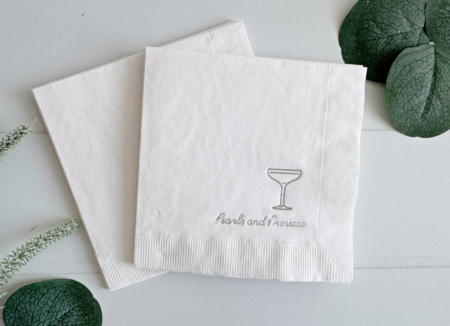 Introducing our silver "Pearls and Prosecco" Bridal Shower and Bachelorette Cocktail Napkins, the epitome of elegance and sophistication for your pre-wedding celebrations. These exquisite napkins feature a pristine white background adorned with intricate silver foil details