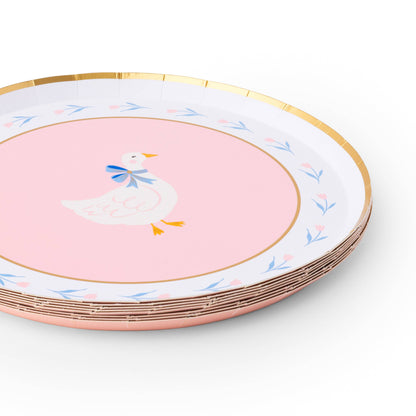Set of decorative party plates with a goose design on a white and pink background