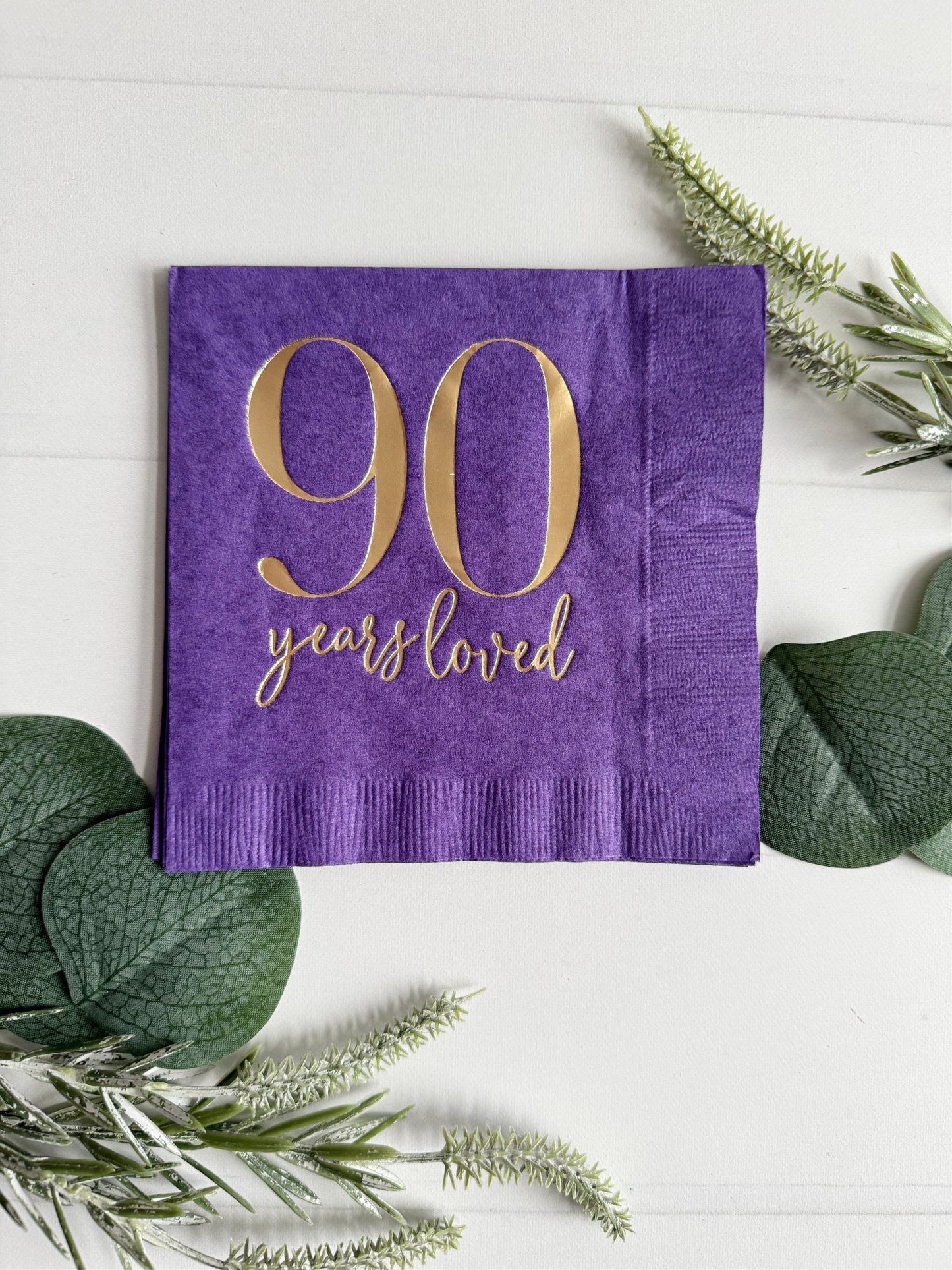 Raise a toast to 90 remarkable years with our purple "90 Years Loved" Cocktail Napkins featuring stunning gold foil accents! These napkins are the perfect addition to your 90th birthday celebration, adding a touch of elegance and style to commemorate this incredible milestone.