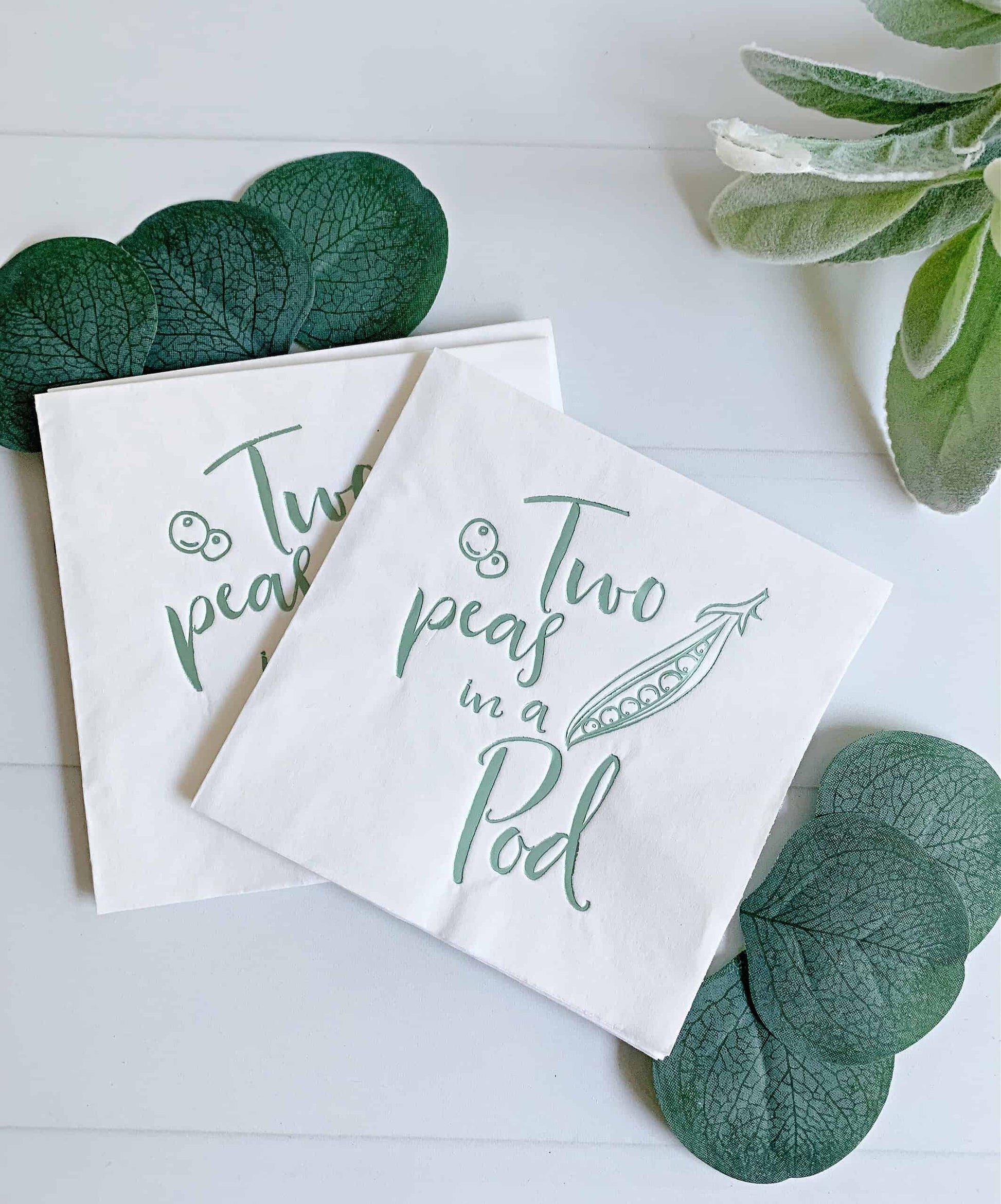 These charming cocktail napkins, featuring a delightful "Two Peas in a Pod" design in elegant sage green foil, are ideal for your baby shower celebration. Specifically designed for twin baby showers, they showcase an adorable motif of cute little peas and pods, all in stunning sage green foil.