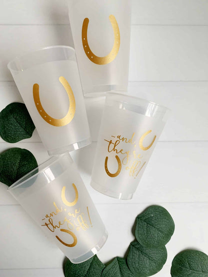 And They're off Kentucky Derby Bridal Shower, Wedding or Party Cups. Get ready for the races with our "And They're Off" Kentucky Derby bridal shower, wedding, or party cups. These stylish cups feature a classic Kentucky Derby design and a playful message, making them the perfect choice for a pre-race celebration or any special occasion. Whether you're serving cocktails, lemonade, or simply adding a touch of fun to your decor, these cups are sure to impress. The durable construction ensures they are long-las