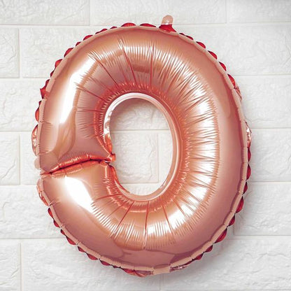 Rose gold Letter O balloon on a white textured background
