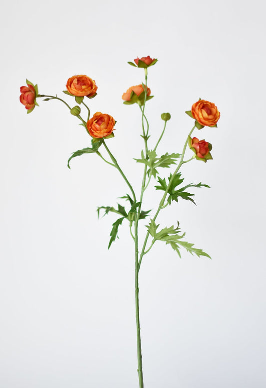 Artificial flower stem with orange ranunculus flowers on a white background